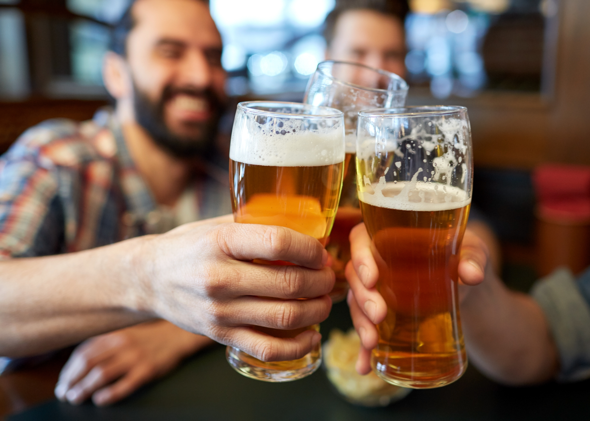happy male friends drinking beer at bar or pub